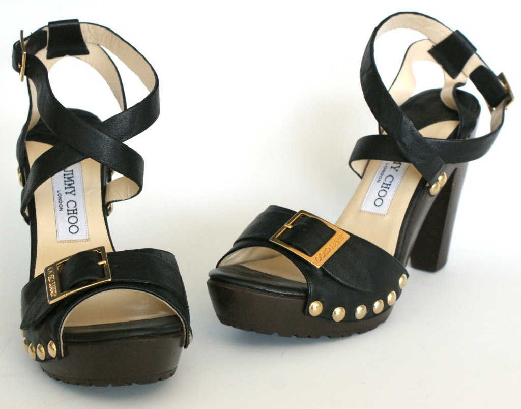JIMMY CHOO UNCANNY CLOG SANDAL, SZ 7.5: Clog sandal heels in 'biker leather black' with metal studs and criss-cross ankle straps. Includes original box and dust bag. One inch platform with 4 inch heel, size 7.5 (38). New, never worn.