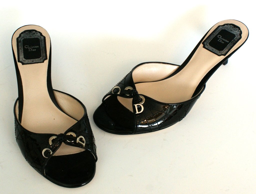 DIOR CANNAGE PATENT LEATHER SLIDE SANDAL, SZ 7: All leather slide sandal with black patent upper, bow accent with silver hardware, includes original box. Size 7 (37.5) with heel height of 1.75 inches. New, never worn.