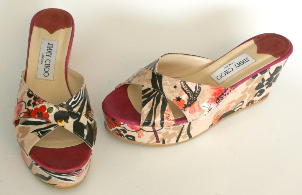 JIMMY CHOO GLAZED CANVAS SLIDES, SZ 7.5: Multi-color print wedge heels with glazed canvas uppers, rubber soles, original box and dust bag. Size 7.5 (38) with heel height of 2.75 inches and platform size of 1 3/8 inches. New, never worn.