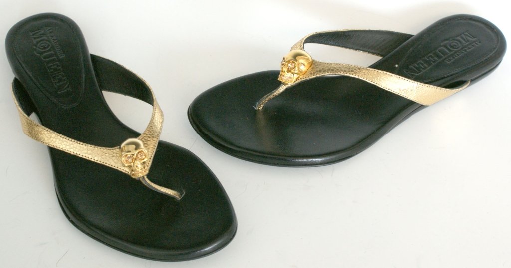 ALEXANDER McQUEEN GOLD SKULL SANDALS, SZ 6.5: Gold flip-flop sandals, gold metal skull with crystal eyes, leather uppers, original box and dust bag. Size 6.5 (37) New, never worn.