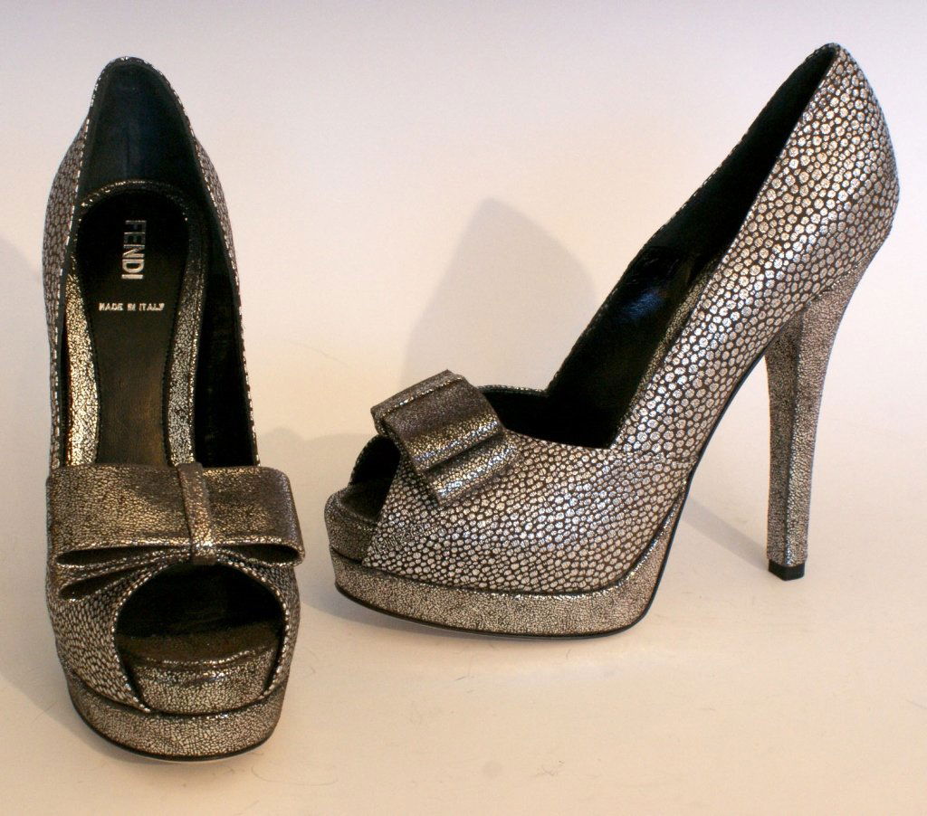 FENDI SILVER BROCADE PLATFORM PEEP TOE PUMPS, SZ 7: Silver and black brocade with accent bow, leather sole, original box and dust bag. Size 7 (37.5) with heel height of 4.75 inches and platform size of.75 of an inch. New, never worn.
