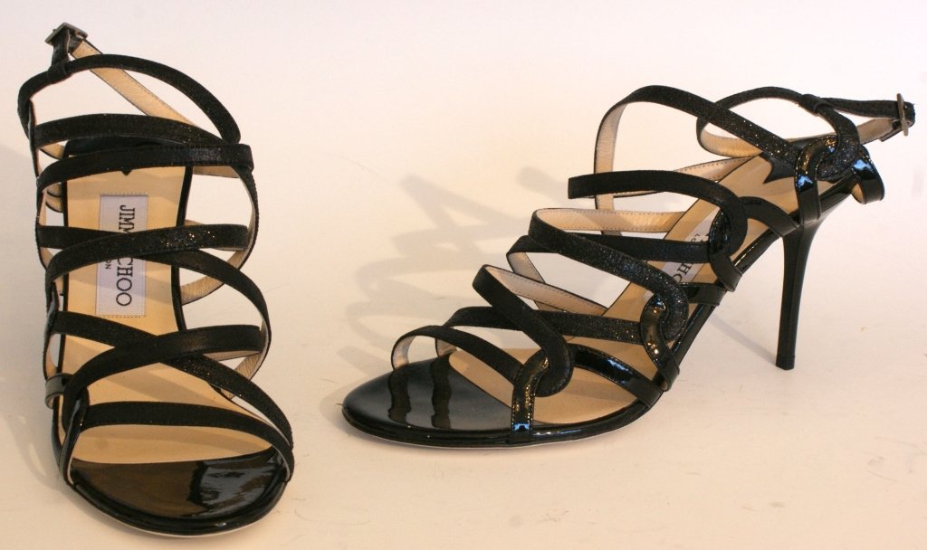 JIMMY CHOO DASH GLITTER SANDALS, SZ 7: Strappy black patent and glitter sandals with buckled ankle strap, leather sole and insole, original box and dust bag. Size 7 (37.5) with heel height of 3 1/4 inches. New, never worn.