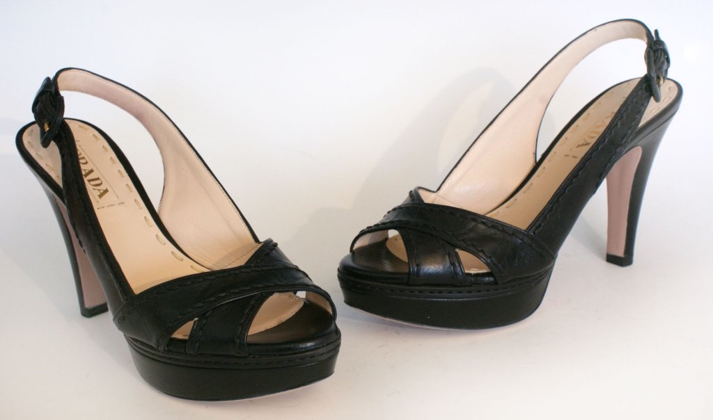 PRADA VITELLO SHINE SLINGBACK PLATFORMS, SZ 7: Black slingback sandals with chunky heel, crisscross toe, all leather, original box and dust bag. Size 7 (37.5) with heel height of 3.75 inches with a platform size of 1 1/8 inches. New, never worn.