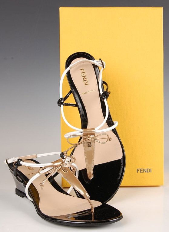 FENDI BOW WEDGE THONG SANDAL, SZ 6.5: Black, white and gold strappy upper with a patent wedge heel, original box. Size 6.5 (37) with heel height of 1.75 inches. New, never worn.