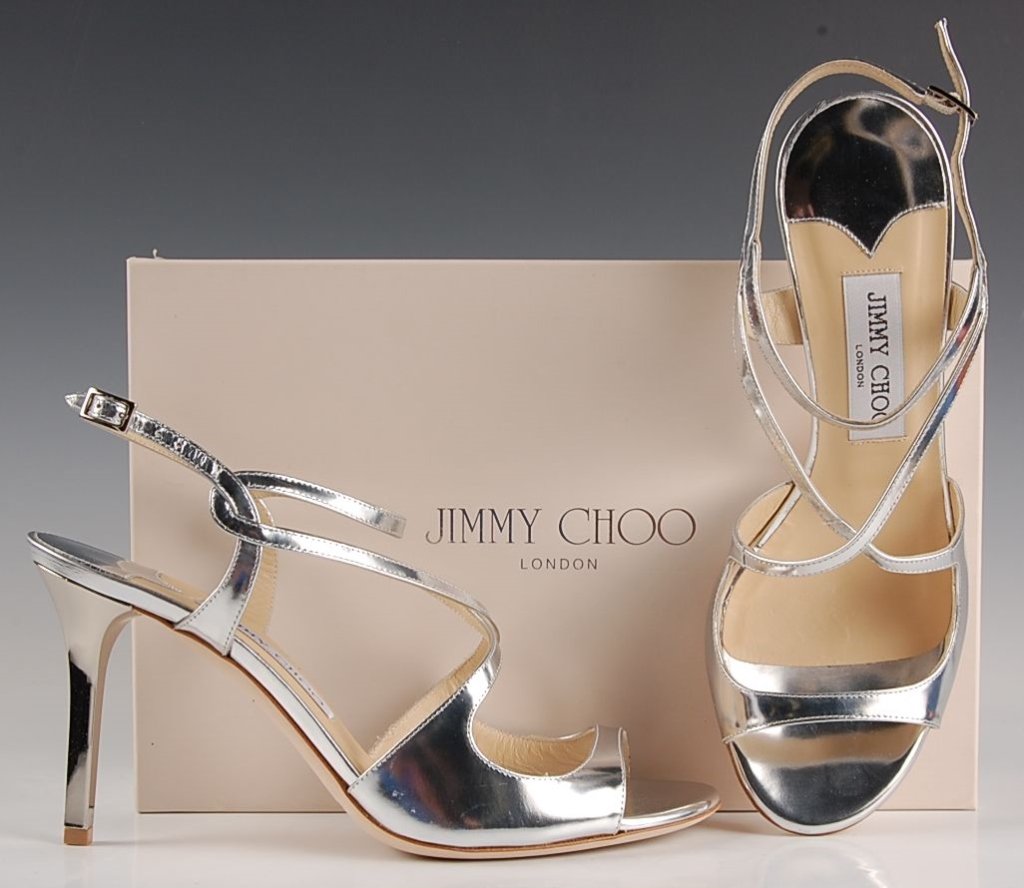 JIMMY CHOO MIRROR LEATHER SILVER SANDAL, SZ 7.5: Strappy sandal in a shiny silver with ankle buckle, leather sole, original box and dust bag. Size 7.5 (38) with heel height of 3 inches. New, never worn.