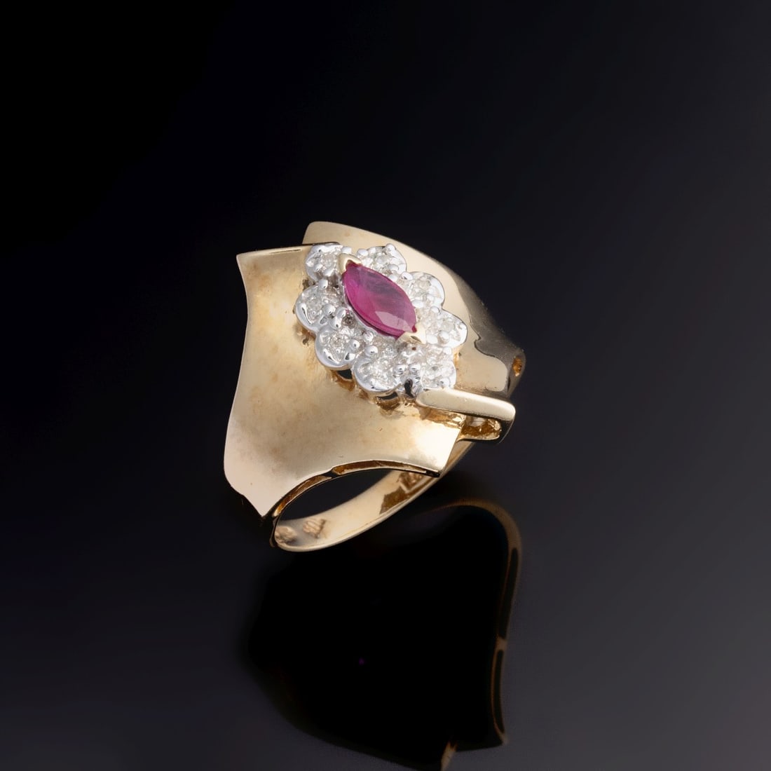 LADY'S SCULPTURAL 10K GOLD RING WITH RUBY AND DIAMONDS: The satin finish modern design ring with a marquise ruby center stone surrounded by eight melee diamonds is stamped 10k LGL. Ring size 6. Weight is 4 grams. Without proof of exemption, be aware that i