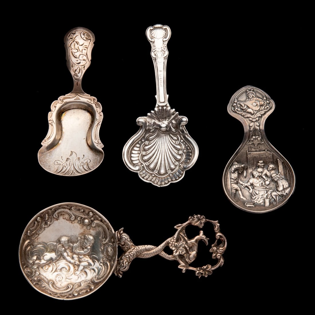A COLLECTION OF STERLING SILVER TEA CADDY SPOONS: Two have British hallmarks, one stamped .800 and the example with a peasant scene in the bowl is simply stamped with squirrel hallmark and numerals 901. Measures 3 to 4.5 inches. Total weight of 2.6 o