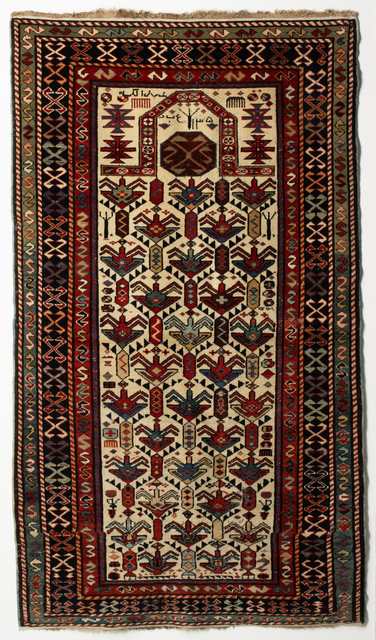 A KUBA PRAYER RUG, NE CAUCASUS, DATED AH 1305/AD 1887 (1 of 18)
