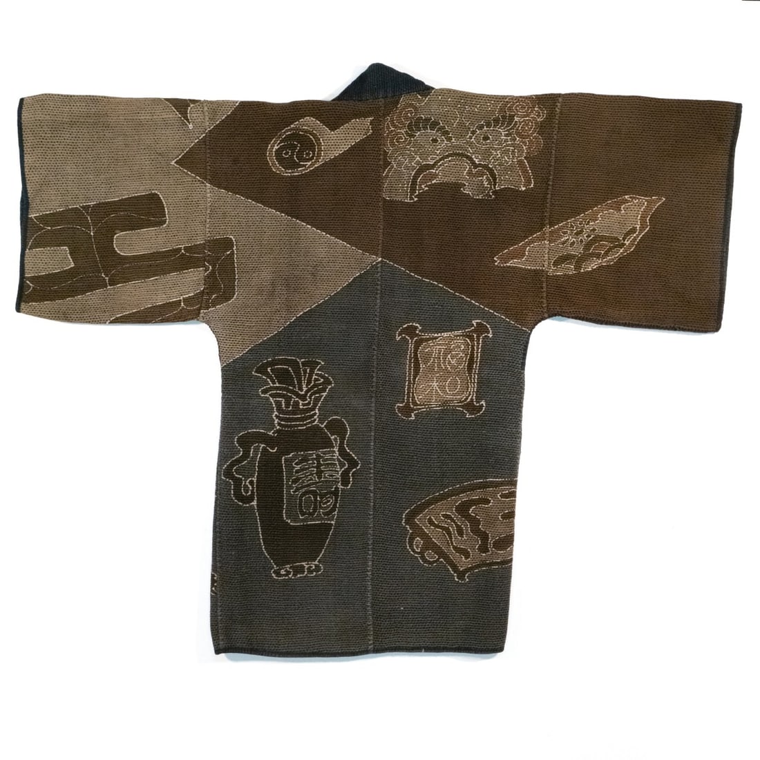JAPANESE FIREMAN'S COAT W/AUSPICIOUS SYMBOLS, ADAIR EST: The rare and unusual 19th century firefighter's jacket of thick multi-layered hand-loomed cotton is dyed in an unusual palette earthy browns, greys, and indigo, the reverse is decorated with a large v