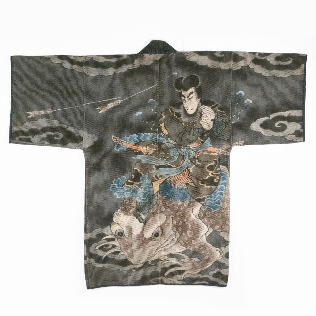 A JAPANESE FIREMAN'S JACKET WITH TSUNADE, ADAIR ESTATE: The rare 19th century firefighter's jacket of thick multi-layered hand-loomed cotton is decorated with a finely executed rendering of Tsunade standing atop a giant toad dodging flying arrows. The imag