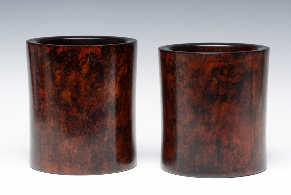 TWO ANTIQUE CHINESE HUANGHUALI BRUSH POTS: Two very similar highly figured wood brush pots with outstanding patina. Measures 6 x 5.25 and 6.25 x 5.5 inches in diameter. Provenance: The estate of John Adair Jr. (1942-2025), founder and propriet