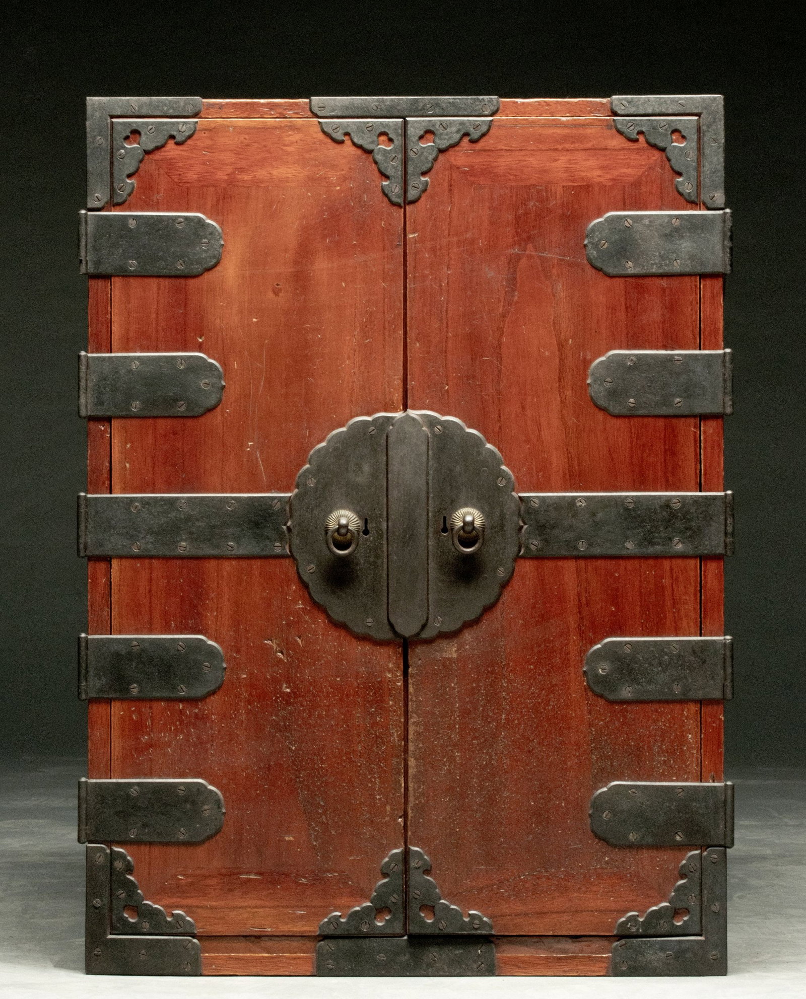 A 19TH CENTURY JAPANESE TWO DOOR CABINET WITH IRON: The Biraki Choba merchant's chest is crafted from chestnut or other hardwood front with iron. Measures 25.25 x 18.25 x 16 inches. Provenance: The estate of John Adair Jr. (1942-2025), founder and prop