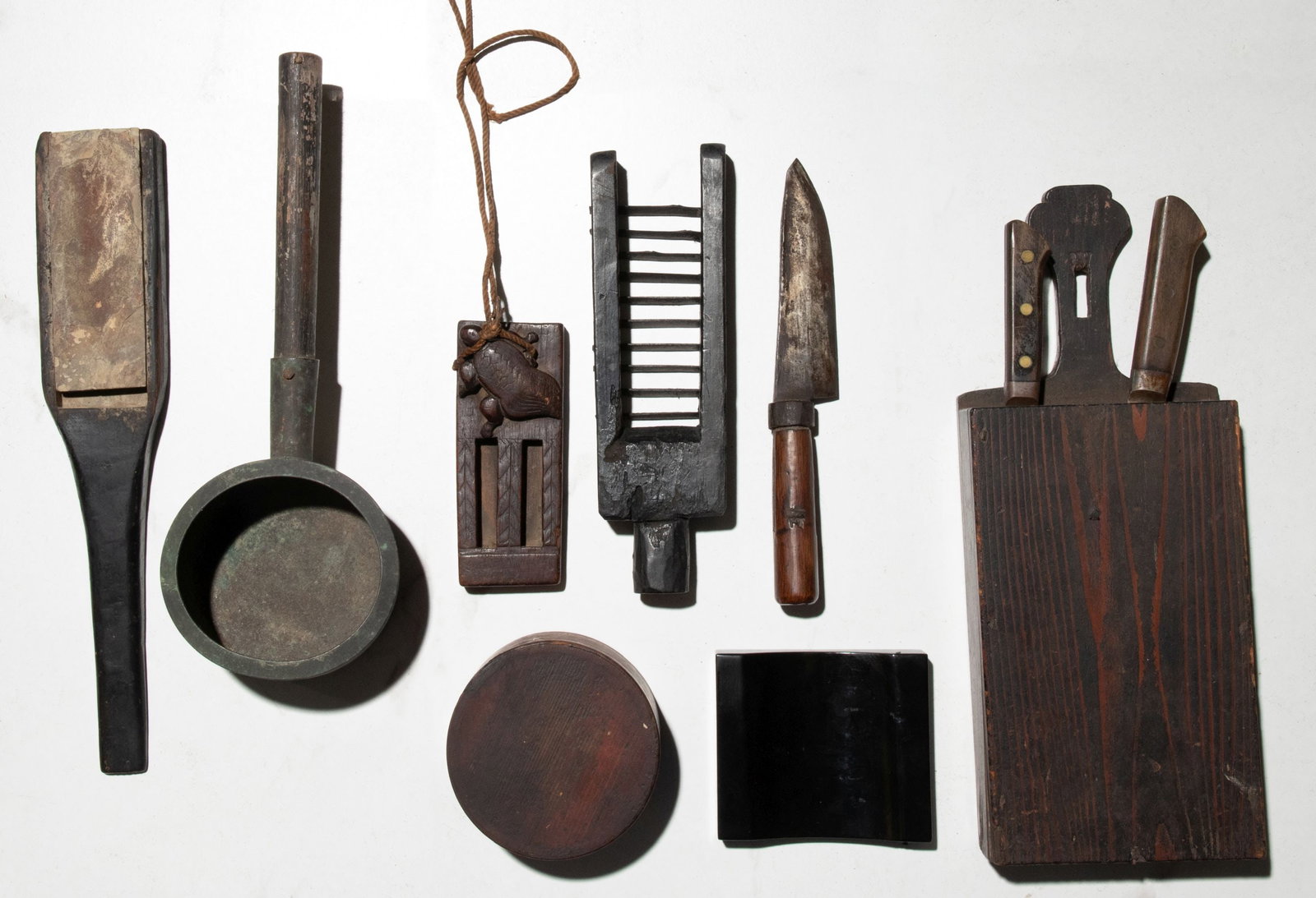 JAPANESE WOOD AND BRONZE OBJECTS FROM THE 19TH CENTURY: The entire collection as shown. Sizes range from 5.25 to 16.75 inches in length. Provenance: The estate of John Adair Jr. (1942-2025), founder and proprietor of Kurofune Antiques, Tokyo (est. 1978). A