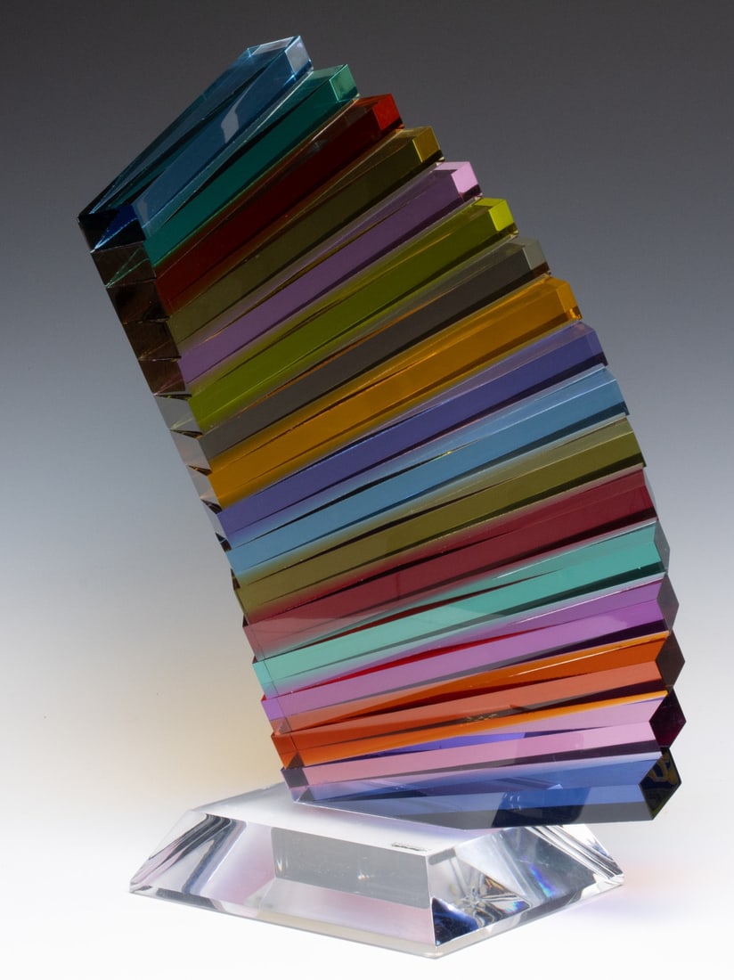 SHLOMI HAZIZA (B. 1969) LUCITE SCULPTURE: Shlomi Haziza (Born 1969) Day By Day The multi-color Lucite sculpture signed on the base and marked with an artist's label. Measures 20 x 13 x 8 inches. Provenance: The estate of John Adair Jr. (1942-