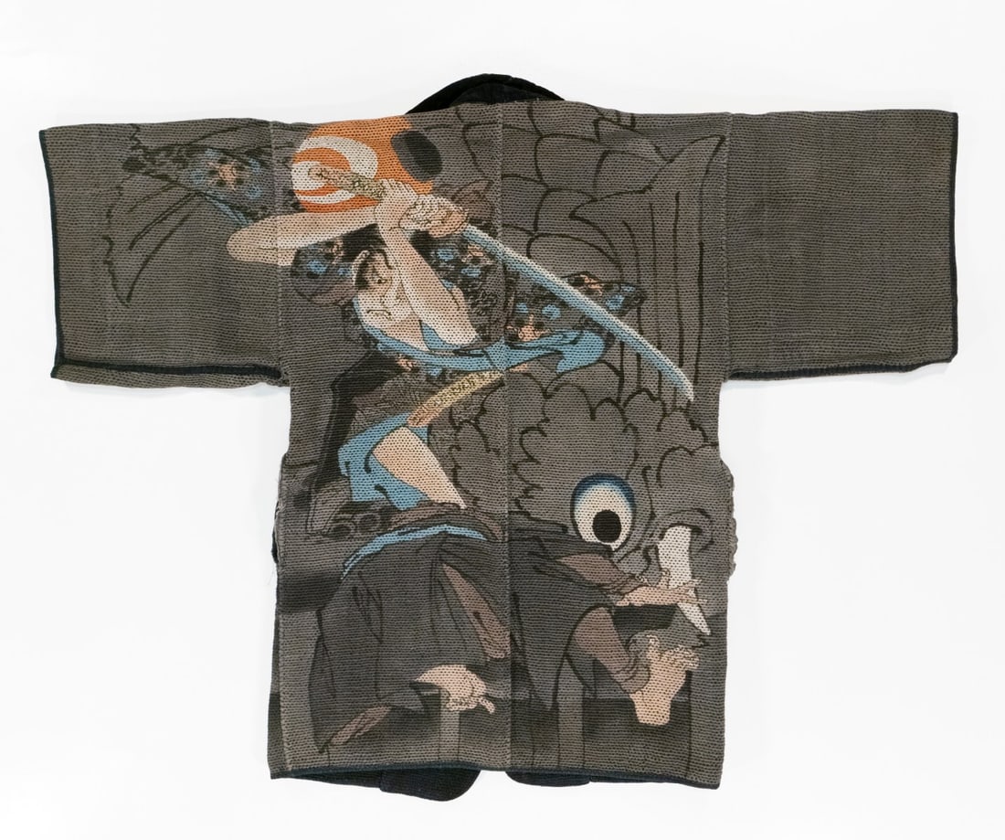 AN ELABORATE 19C. JAPANESE FIREMAN'S COAT SIGNED HIRAI: The rare artist-signed 19th century 'firefighter's' coat was made by hand stitching together multiple layers of loomed cotton fabric using thousands of sashiko stitches. The striking design features a