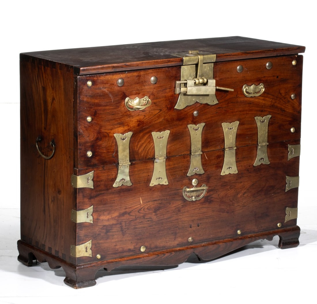 A 19TH CENTURY KOREAN BRASS BOUND CABINET: With dovetailing along the top corner of each side and good patina. Measures 30.5H x 39W x 16D inches. Provenance: The estate of John Adair Jr. (1942-2025), founder and proprietor of Kurofune Antiques