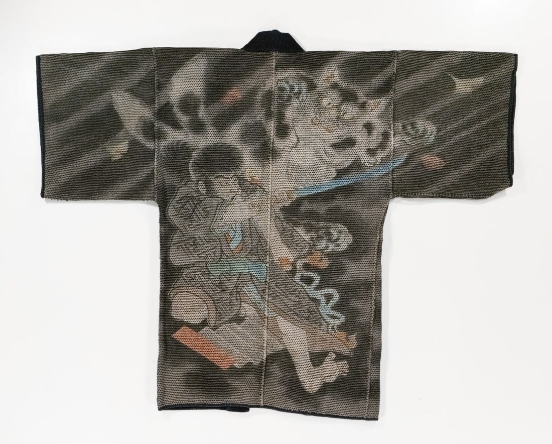 A FINE JAPANESE FIREMAN'S COAT W/ SAMURAI, ADAIR ESTATE: The rare 19th century 'firefighter's' coat, made by hand stitching together multiple layers of loomed cotton fabric using thousands of sashiko stitches, features a sword-wielding samurai and demon