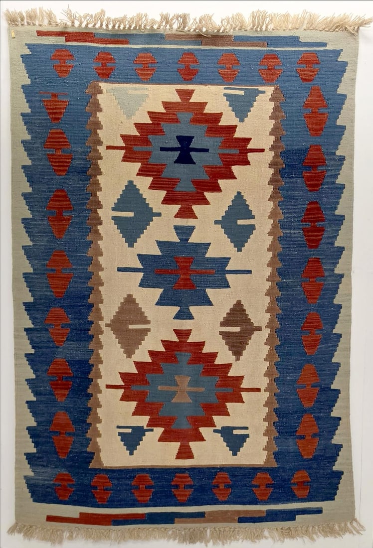 A FINE MODERN TURKISH KELIM, CENTRAL TURKIYE: With stepped medallions on ivory field within a blue border. Measures approximately 71 x 44 inches; 5ft.11 inches x 3ft.8in; 181 x 112cm. Provenance: The estate of John Adair Jr. (1942-2025), founder 