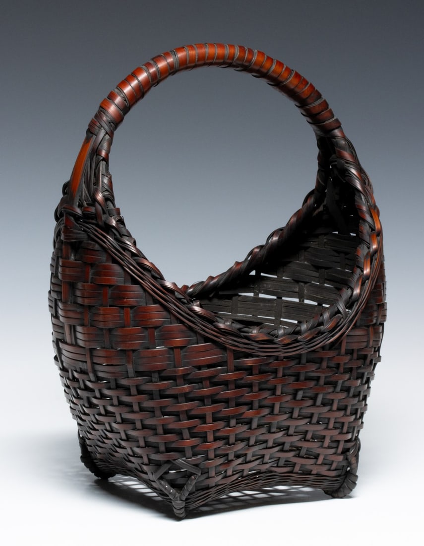 AN EXCEPTIONAL JAPANESE IKEBANA BASKET, ADAIR ESTATE: The beautiful example of exceptional color, patina, form, composition and craftsmanship is meticulously woven in something of a 'sailing boat' form. The four-cornered base is elevated by distinctive