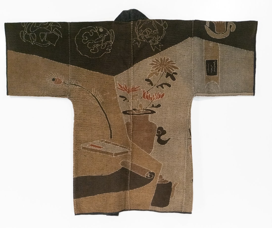 AN UNUSUAL MEIJI JAPANESE FIREMAN'S COAT, ADAIR ESTATE: The unusual 19th century 'firefighter's' coat, made by hand stitching together multiple layers of loomed cotton fabric using thousands of sashiko stitches, features designs picturing objects related t