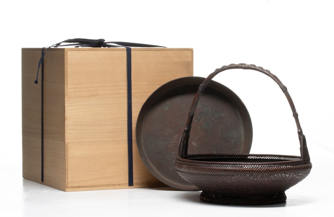 CHIKUUNSAI JAPANESE BAMBOO FLOWER BASKET, ADAIR ESTATE: The wide, meticulously woven shallow tray form is constructed using a combination of dense twill plaiting on the lower body and an extraordinarily fine mesh on the upper flared rim. The high, sweeping