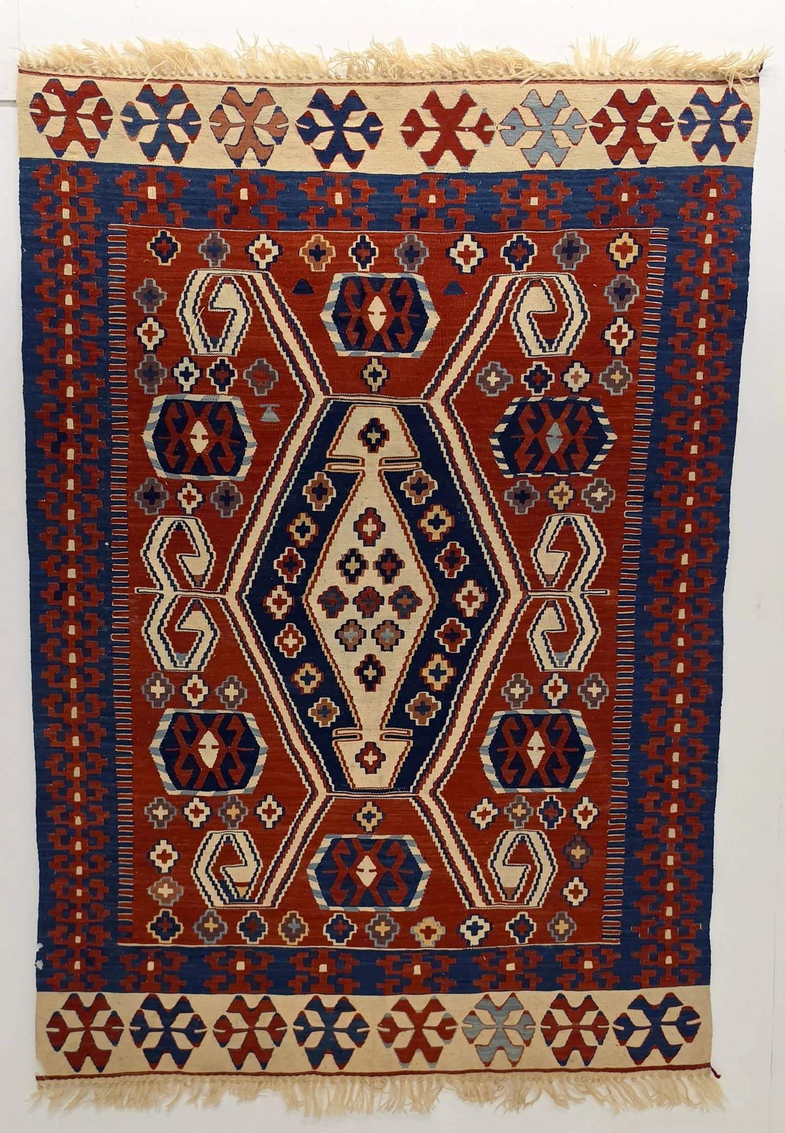 A FINE MODERN TURKISH KELIM, CENTRAL TURKIYE: The fine kelim with latch hooked hexagonal lozenge medallion is framed by a red border and ivory banded ends. Measures approximately 64 x 45 inches; 5ft.4 inches x 3ft.9in; 163 x 115cm. Provenance: Th