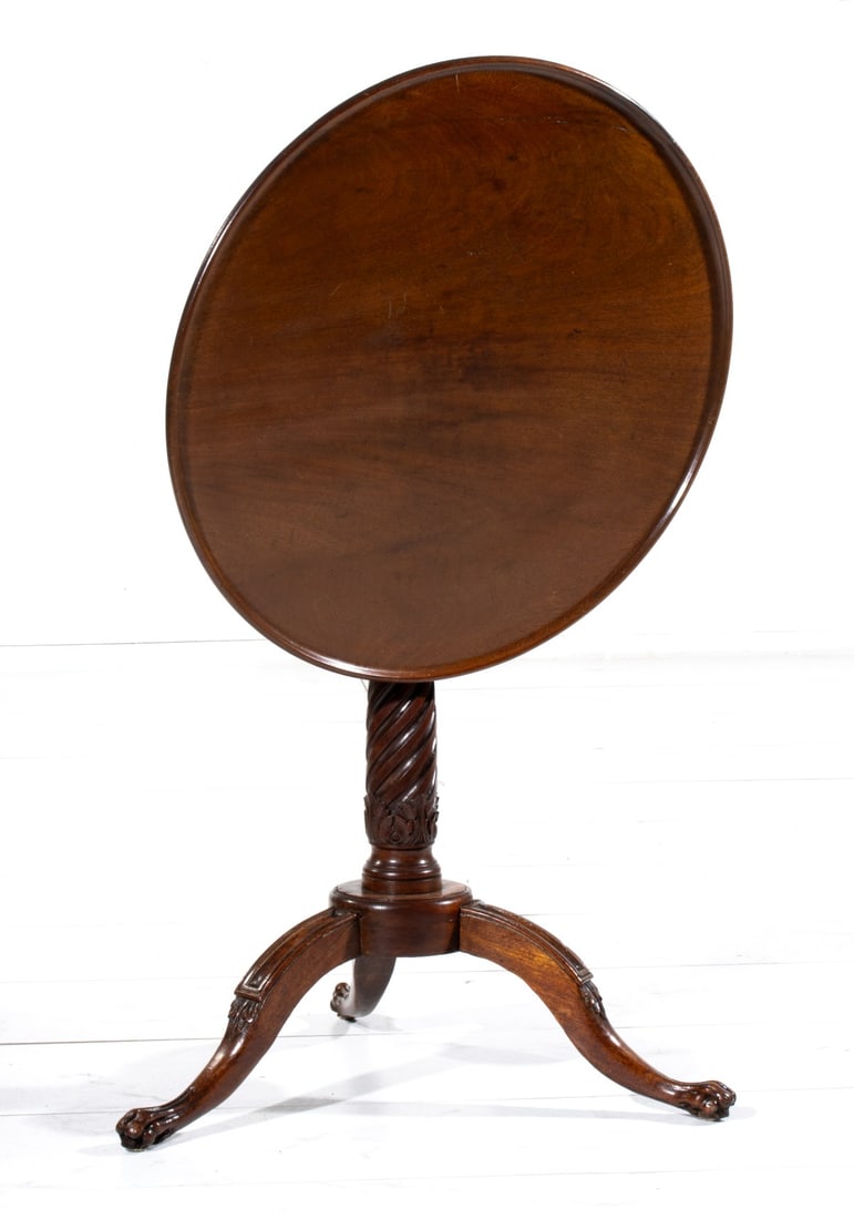 A 19TH C. FRENCH WALNUT TILT-TOP TABLE W/ MAKER'S STAMP: The the circular tilting top on a twist carved vase with acanthus is raised on tripod base having four carved toes. Stamped signature on the block. Measures 28.5 x 25 inches in diameter. Tilted height