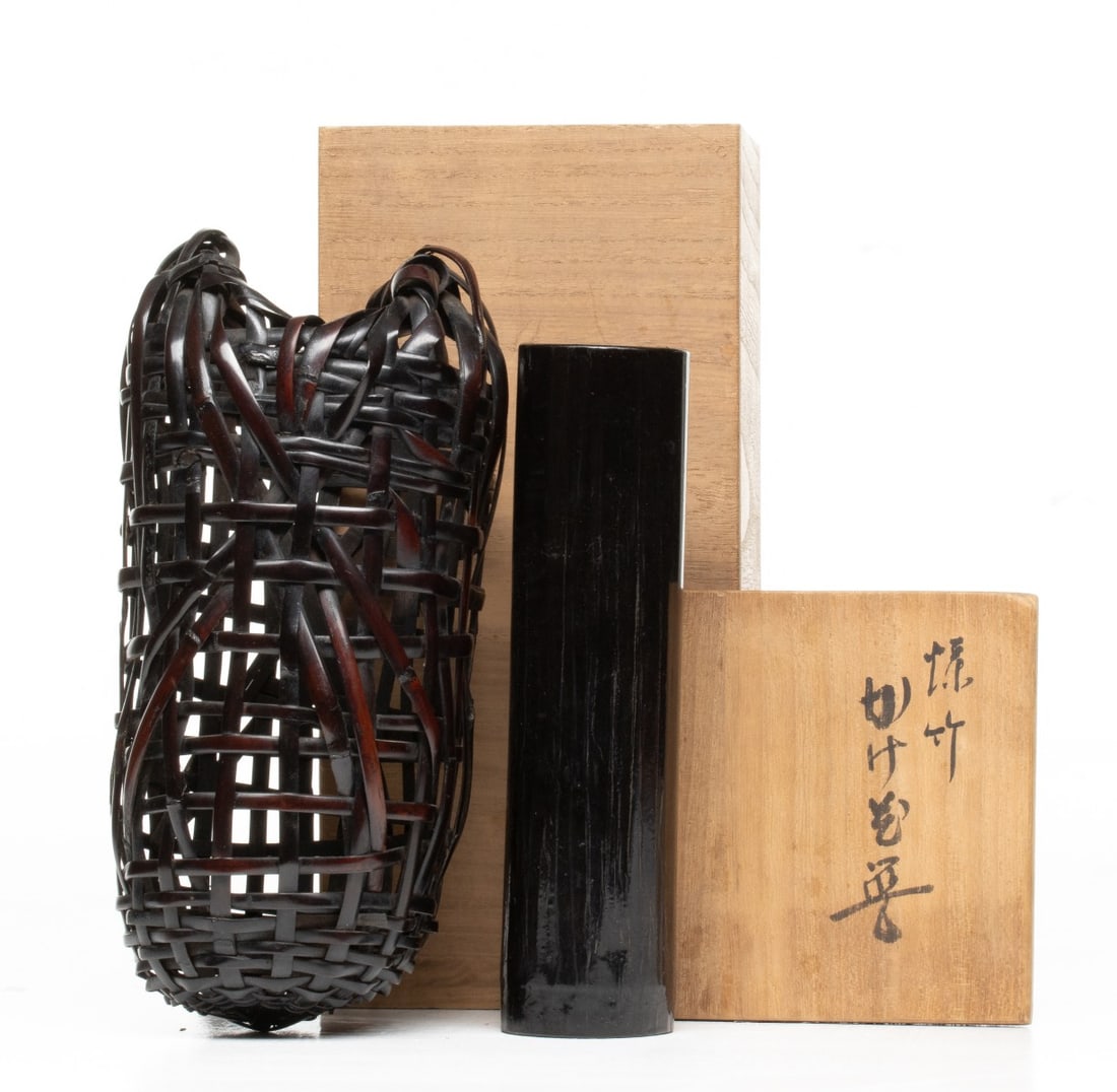 MAEDA CHIKUBOSAI II SMOKED BAMBOO BASKET, ADAIR ESTATE: The elongated, asymmetric hanging basket is of an openwork rough-weaving technique that utilizes wide, deeply patinated slats of historic susudake, bamboo that is naturally dark-toned and smoke-cured 