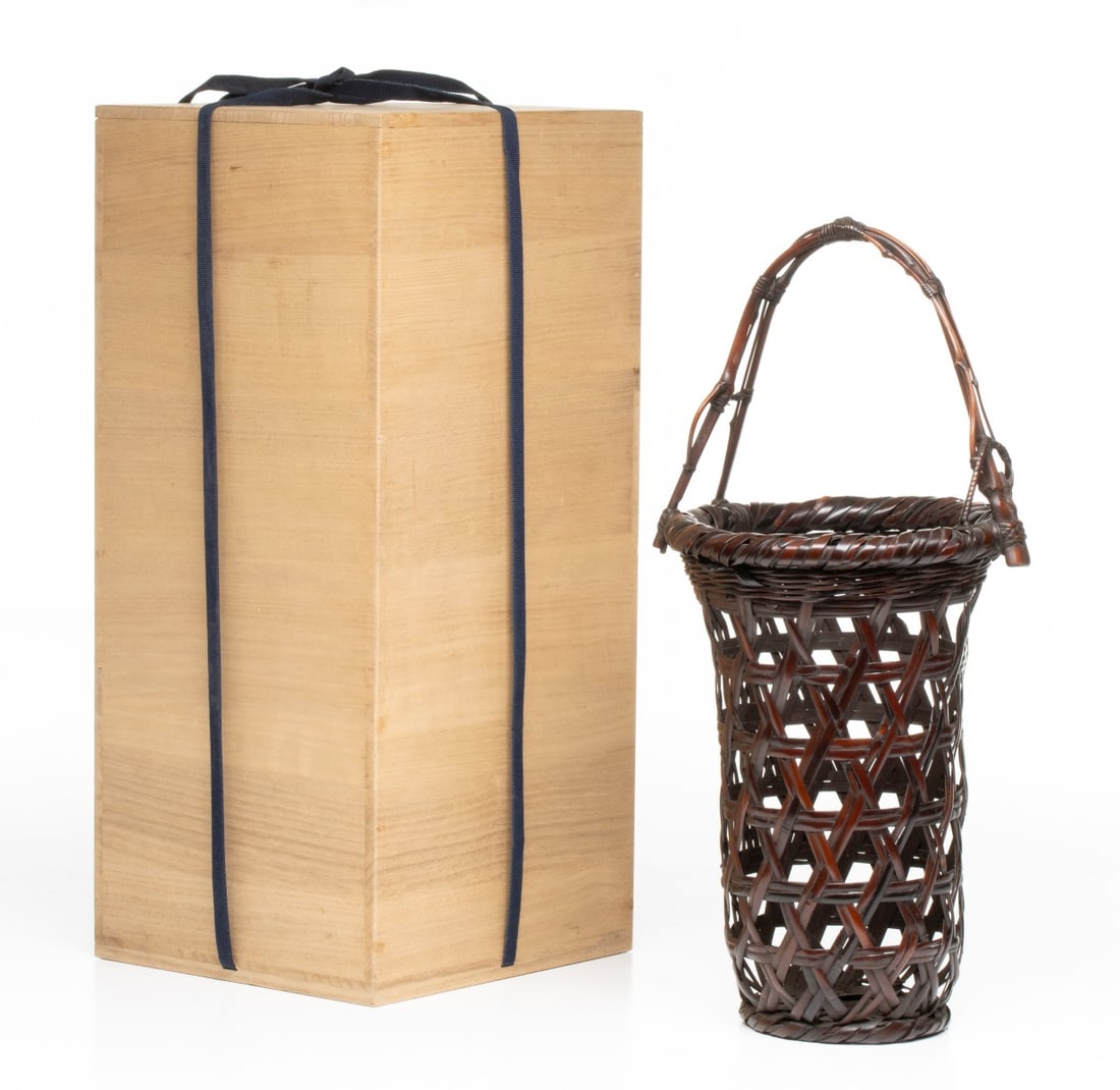 YAMASHITA KOCHIKUSAI (1876-1947) IKEBANA BASKET, ADAIR: The tapering trumpet-form vessel is executed using a nicely balanced hexagonal basket plaiting integrating horizontal bamboo ribs. The flares at the upper shoulder, terminating in a thick, tightly wra