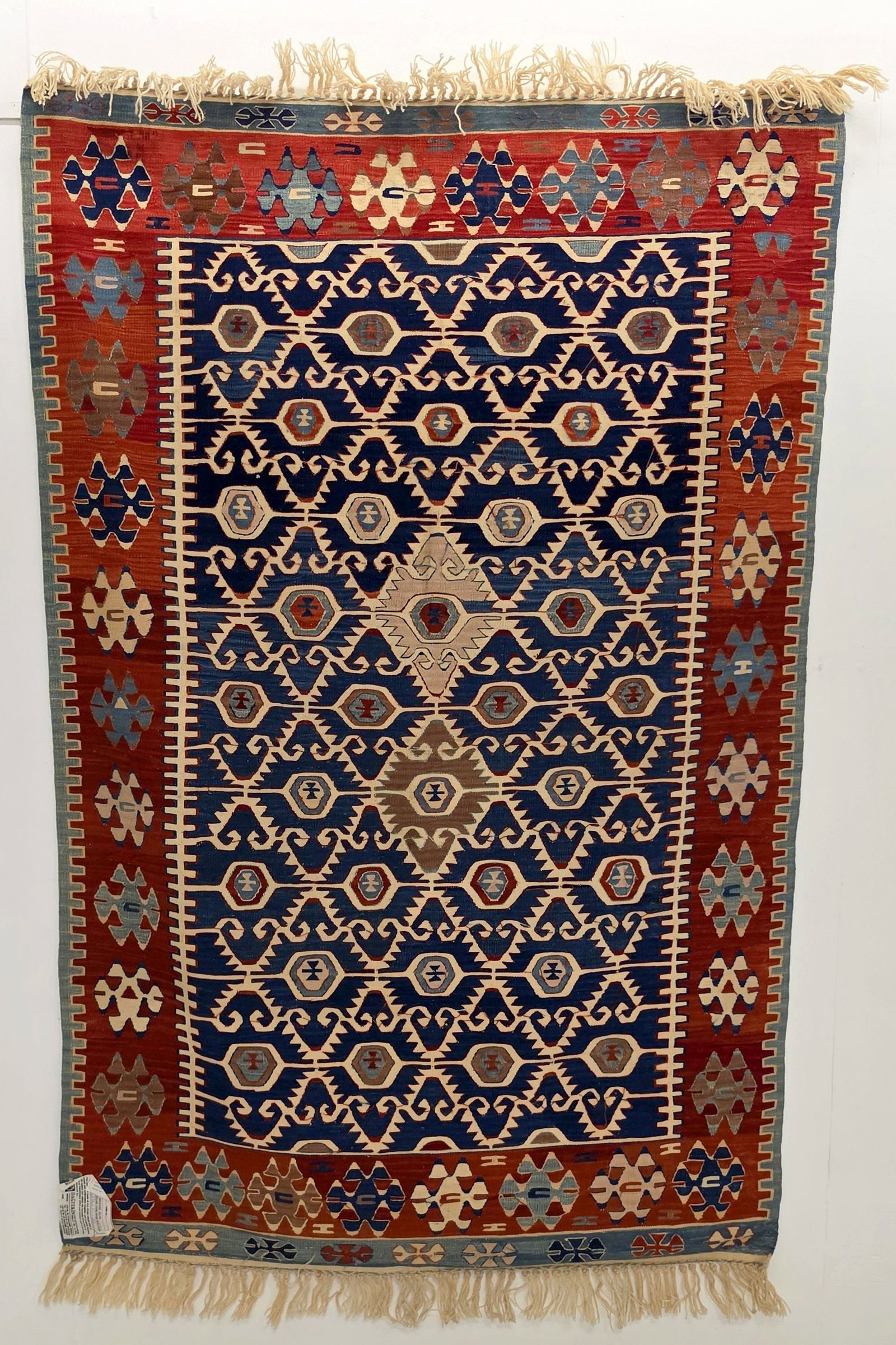 A FINE MODERN TURKISH KELIM, CENTRAL TURKIYE: With overall lattice field in red border. Measures approximately 70 x 46 inches; 5ft.10 inches x 3ft.10in; 178 x 117cm. Provenance: The estate of John Adair Jr. (1942-2025), founder and proprietor of 
