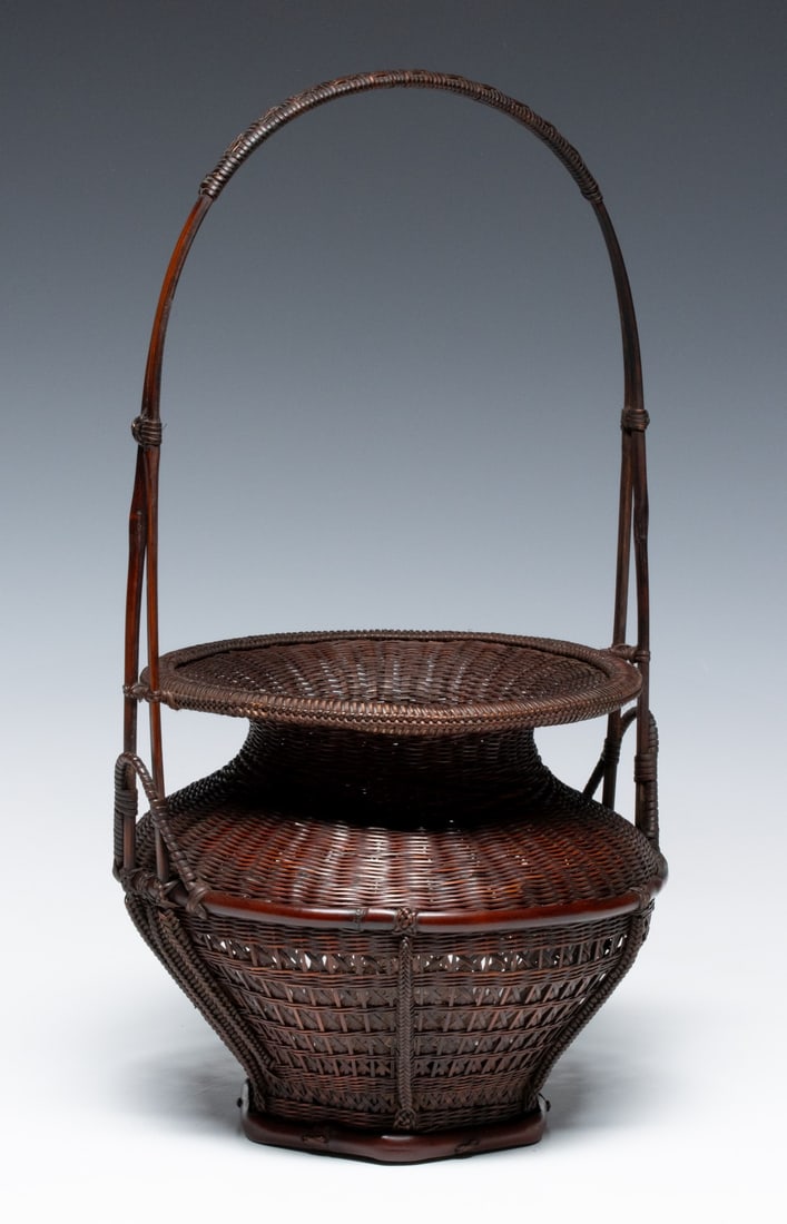 AN ARTIST-SIGNED JAPANESE IKEBANA BASKET, ADAIR ESTATE: The basket of multi-layered construction is woven in a wide, bulbous body tapering to a constricted neck below a broad, horizontal flared rim. The weave transitions seamlessly from a dense horizontal 
