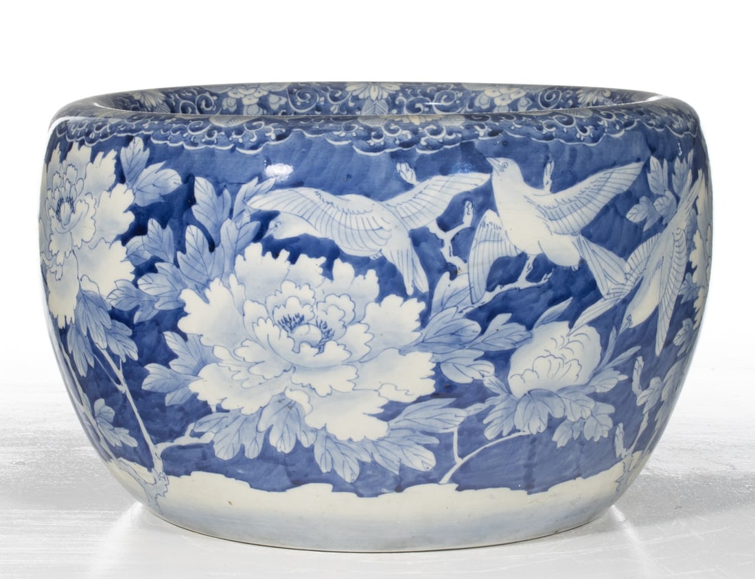 AN EARLY 20C JAPANESE BLUE & WHITE PORCELAIN HIBACHI: The large hand painted blue and white porcelain hibachi is decorated with birds and chrysanthemums in hand painted cobalt. Measures 10.75 x 17.5 inches in diameter. Provenance: The estate of John Adai