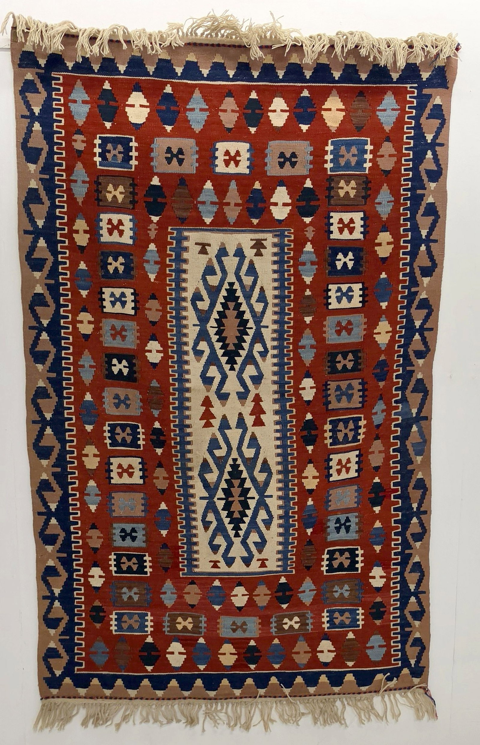 A FINE MODERN TURKISH KELIM, CENTRAL TURKIYE: With end-to-end latch hooked medallions in ivory with a wide border filled with floating devices. Measures approximately 68 x 44 inches; 5ft.8 inches x 3ft.8in; 173 x 112cm. Provenance: The estate of 