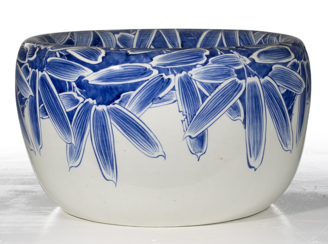 AN EARLY 20C. JAPANESE BLUE & WHITE HIBACHI W/ BAMBOO: The large hand painted blue and white porcelain hibachi is decorated at the rim in hand painted cobalt. Measures 12.25 x 21.25 inches in diameter. Provenance: The estate of John Adair Jr. (1942-2025),