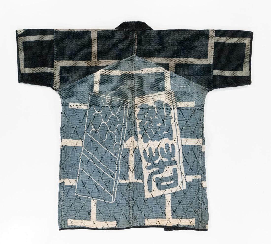 A JAPANESE SASHIKO & QUILTED FIREMAN COAT, ADAIR ESTATE: An actual firefighter's jacket, this unusual example displays multiple color combinations of dye resist brick motif and two different sashiko techniques, one being a larger stitch in black on cotton f