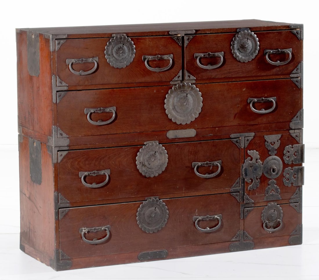 AN 18TH/19TH C. JAPANESE CLOTHING CHEST IN TWO SECTIONS: The 18th to early 19th century two-piece cedar cabinet is fronted in keyaki wood and with iron mounts. Measures 39 total height x 46.5W x 17.5D inches. Provenance: The estate of John Adair Jr. (1942-2