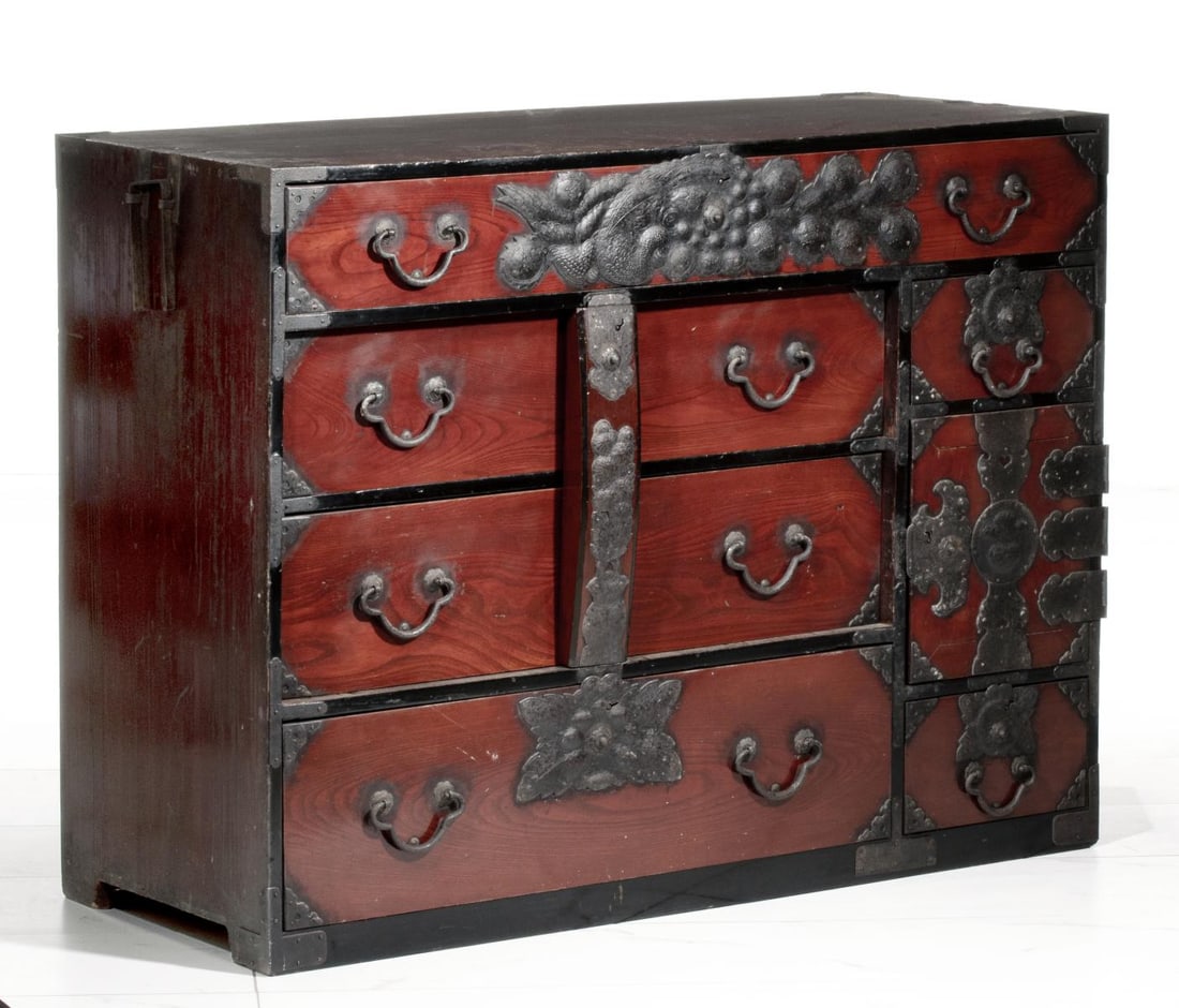 A 19TH CENTURY JAPANESE SENDAI AREA CLOTHING CHEST: The early 19th century cedar cabinet is fronted in keyaki wood and with ornate iron mounts with incised decoration. Measures 36 x 47.5 x 19 inches. Provenance: The estate of John Adair Jr. (1942-2025)