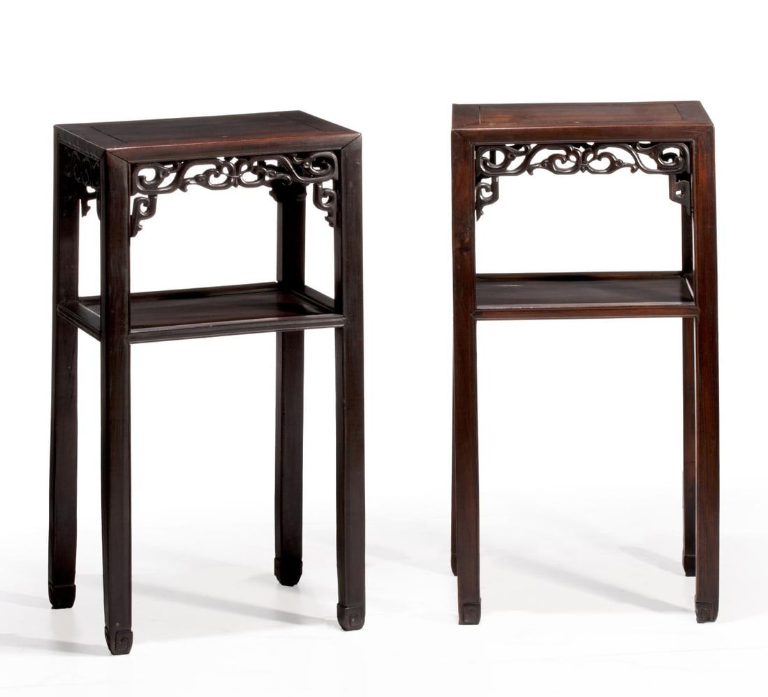 A PAIR OF LATE QING CHINESE HARDWOOD STAND TABLES: The rectangular top of each with inset panel within mortise and tenon frame, above a pierced apron carved with ruyi scrolls. Each measures 32 x 16.25 x 12 inches. Provenance: The estate of John Adair 