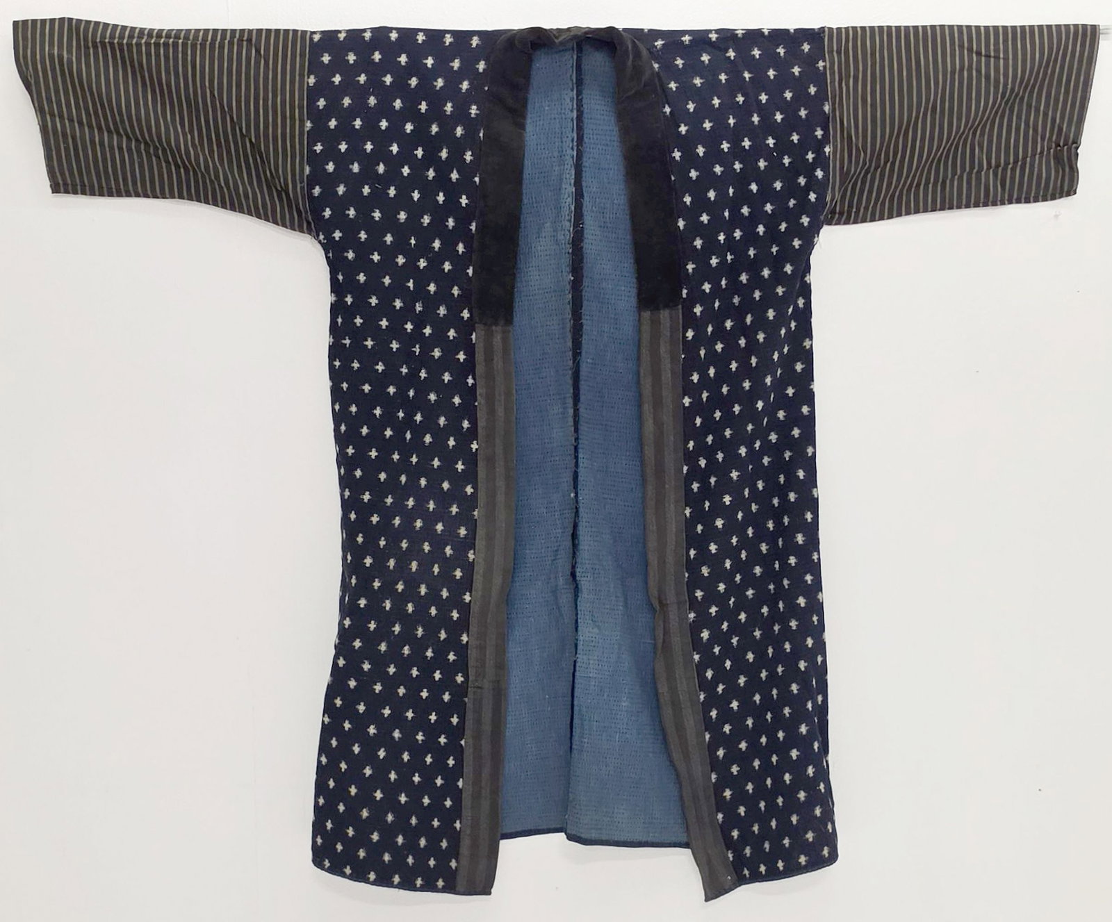 AN EARLY 20TH CENTURY INDIGO DYED JAPANESE HAPPI COAT: Measures 41 x 49 inches. Provenance: The estate of John Adair Jr. (1942-2025), founder and proprietor of Kurofune Antiques in Tokyo (est. 1978), a world-renowned destination for Japanese basketry, pri