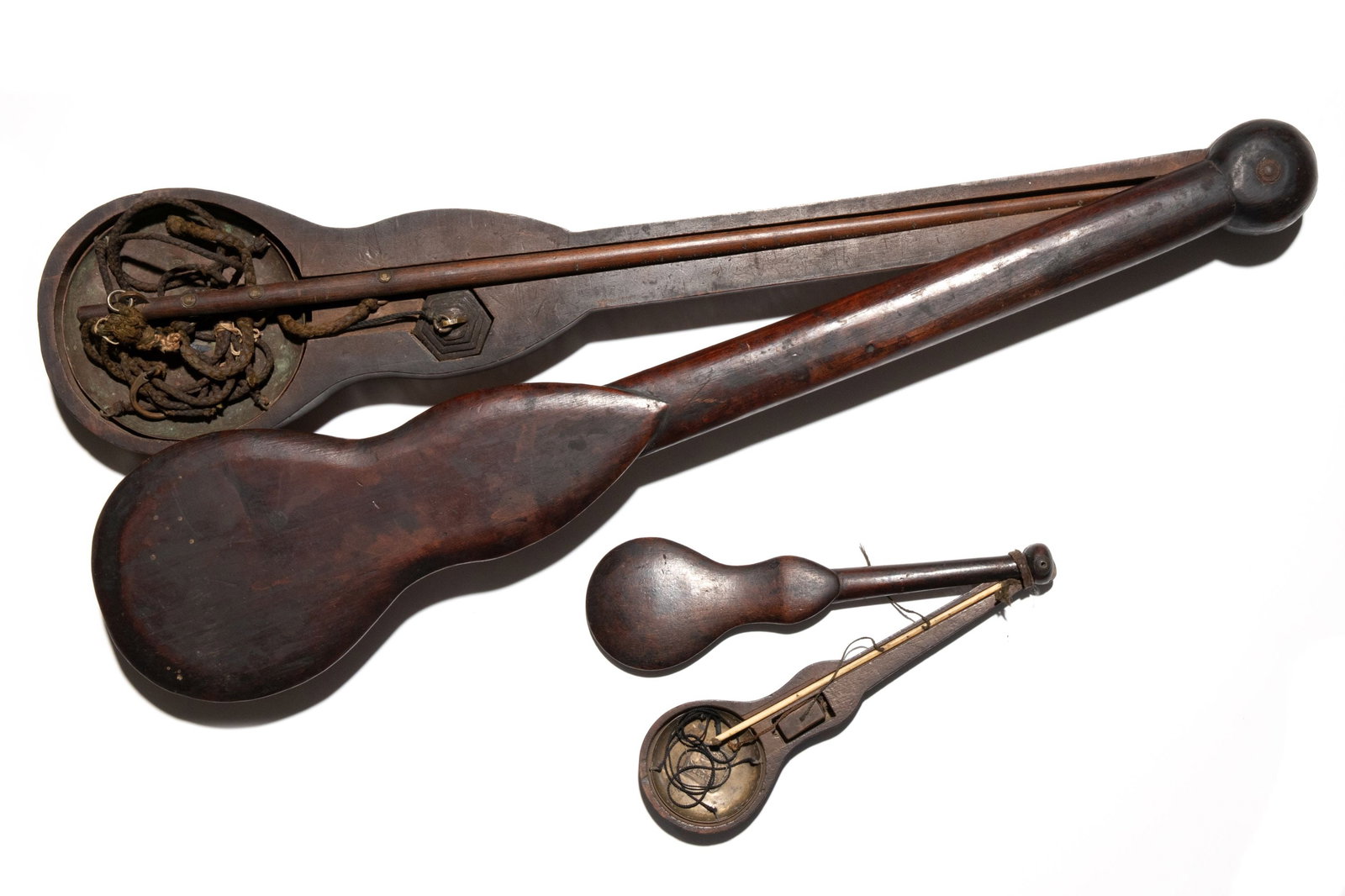 TWO EARLY TO MID 19TH C. JAPANESE WOOD CASED SCALES: The two hand-held beam scales of brass and wood are found in finely crafted fiddle shape two-piece wood cases. Measures 9.5 x 3 and 25.25 x 5.5 inches. Provenance: The estate of John Adair Jr.