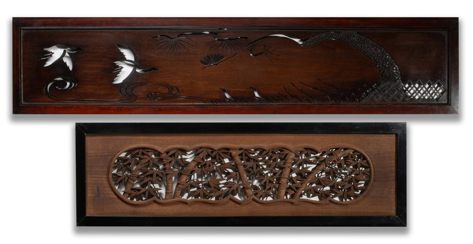 TWO ELABORATELY CARVED JAPANESE HARDWOOD TRANSOMS: Pierce carved examples of openwork bamboo and keyaki wood with flying cranes. Measures 15 x 68.5 and 16 x 51.5 inches. Provenance: The estate of John Adair Jr. (1942-2025), founder and proprietor of K