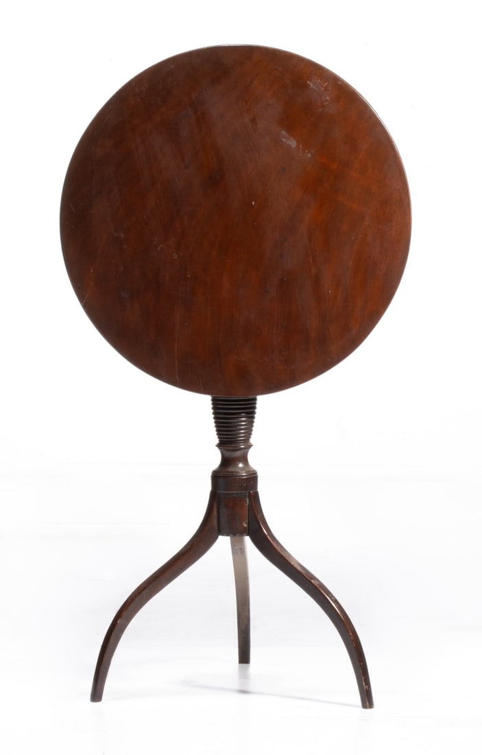 A CHERRY FEDERAL STYLE 18TH C. SPIDER LEG CANDLESTAND: The circular top and distinctive vase with concentric rings are raised on fine spider legs. Measures 28.5 x 21.25 inches. Provenance: The estate of John Adair Jr. (1942-2025), founder and proprietor o