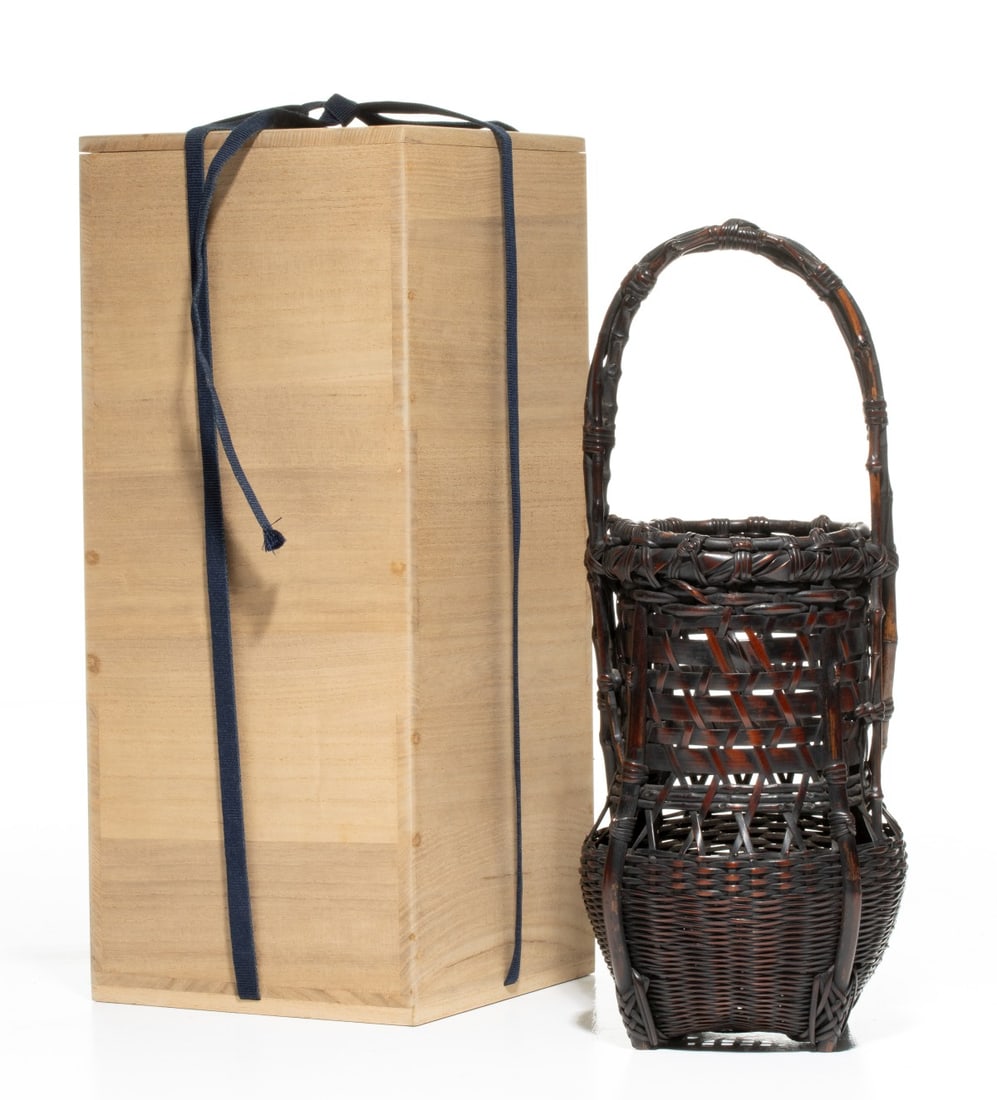 HANDSOME BAMBOO BASKET SIGNED CHIKUBOSAI, ADAIR ESTATE: The fine and handsome example blends an architectural spirit with a host of unique details. The squared, bulbous lower body is constructed in a dense, tight horizontal twill weave rising to meet a wid