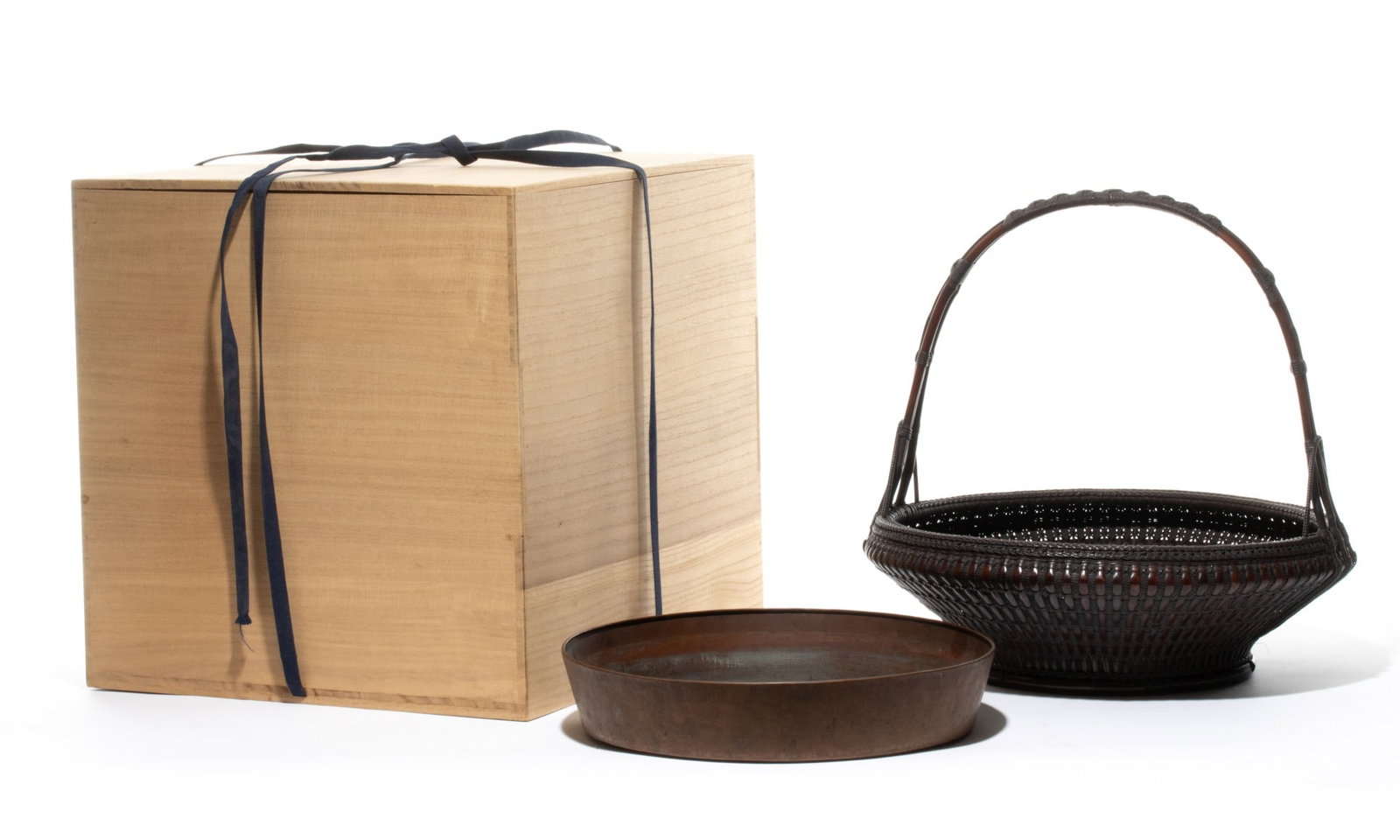 MADEA CHIKUBOSAI (1872-1950) HANAKAGO, ADAIR ESTATE: The finely constructed, shallow bowl-shaped Japanese tea ceremony bamboo flower basket features a substantial triple-branched overhead handle and a matching fitted copper liner. The exterior walls are