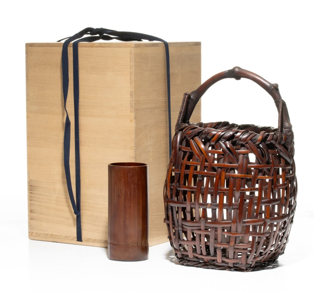 SHONO SHOUNSAI (1904-1974) BAMBOO FLOWER BASKET, ADAIR: The rustic dark-patinated bamboo basket for flower arranging is of square openwork construction embracing the wabi-sabi aesthetic utilizing wide, thick, bamboo staves bound in a robust, open cross-hat