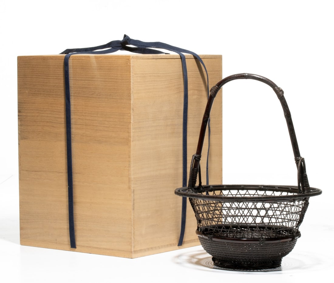 AN ARTIST SIGNED JAPANESE IKEBANA BASKET, ADAIR ESTATE: The finely crafted Japanese bamboo basket for flower arranging features an interesting openwork rim with an ornamental looped bamboo outer ring bound with delicate rattan wrapping. The main body exhib