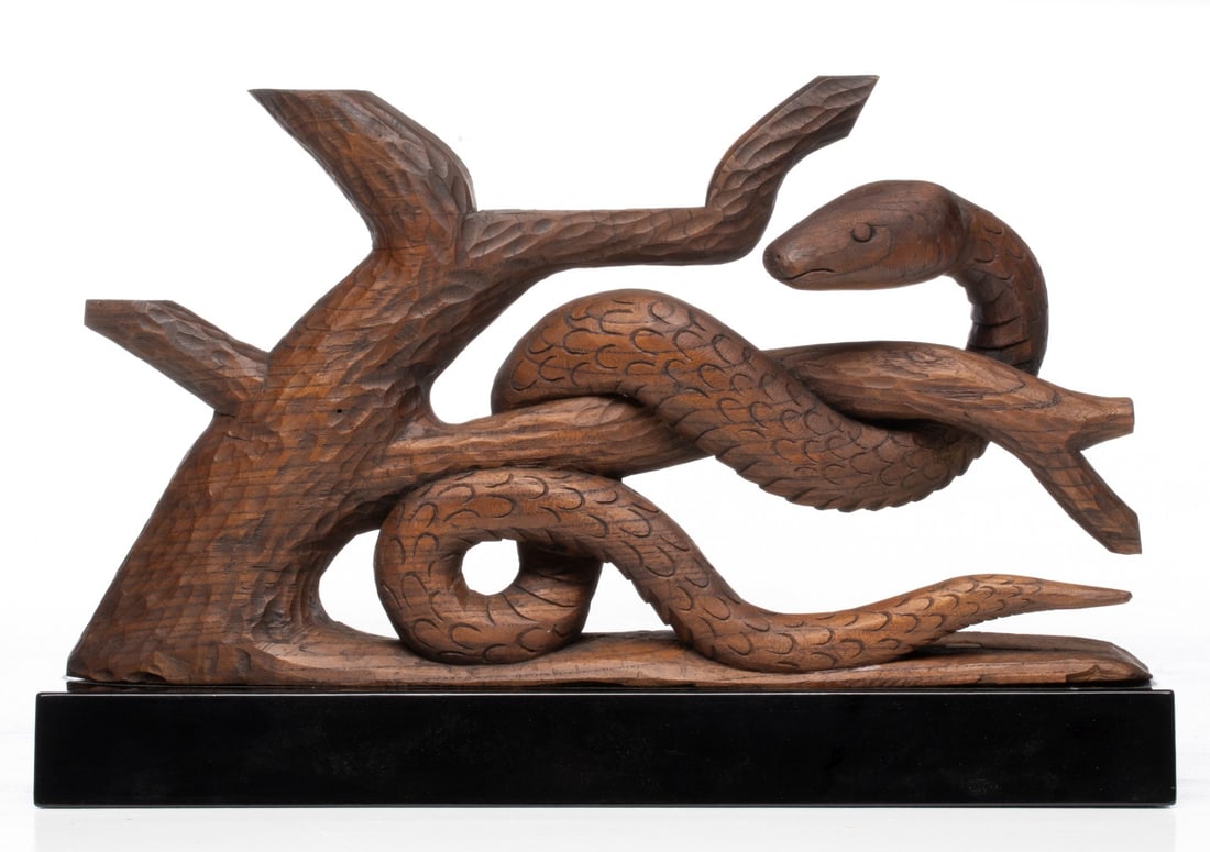 A JAPANESE CARVED KEYAKI WOOD SIGN OF THE ZODIAC: The unsigned, hand carved figure of a snake, one of the twelve animals of the Japanese zodiac, is displayed on a finely lacquered stand and accompanied by a fitted paulownia wood tomobako. Measures 10