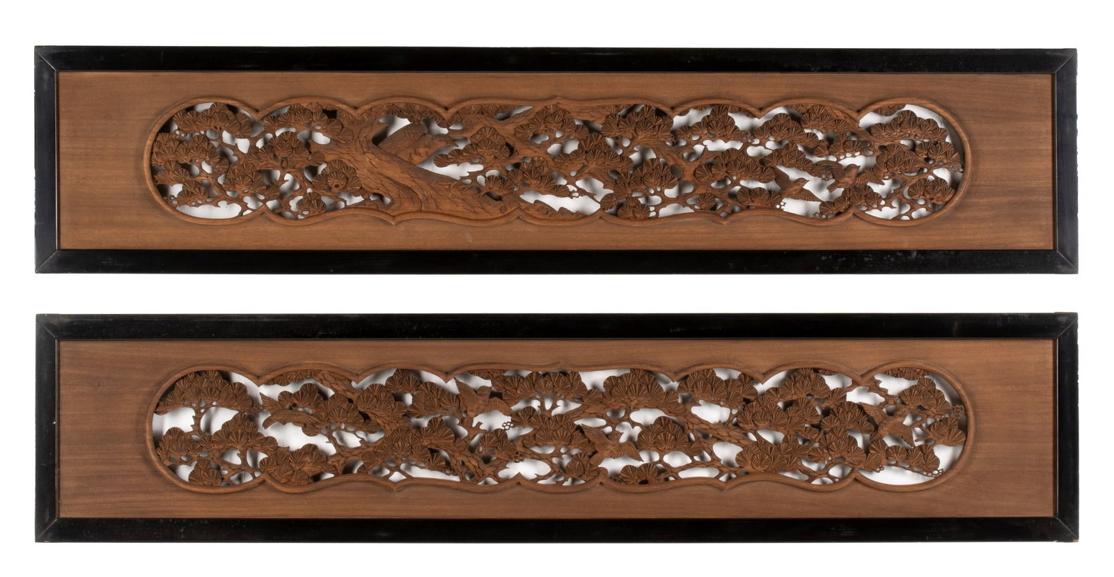 A PAIR OF FINELY CARVED JAPANESE TRANSOM PANELS: Each elaborate openwork carving depicts pine boughs and birds, the pair is signed with an unidentified artist's seal. Each measures 16 x 72.5 inches. Provenance: The estate of John Adair Jr. (1942-202