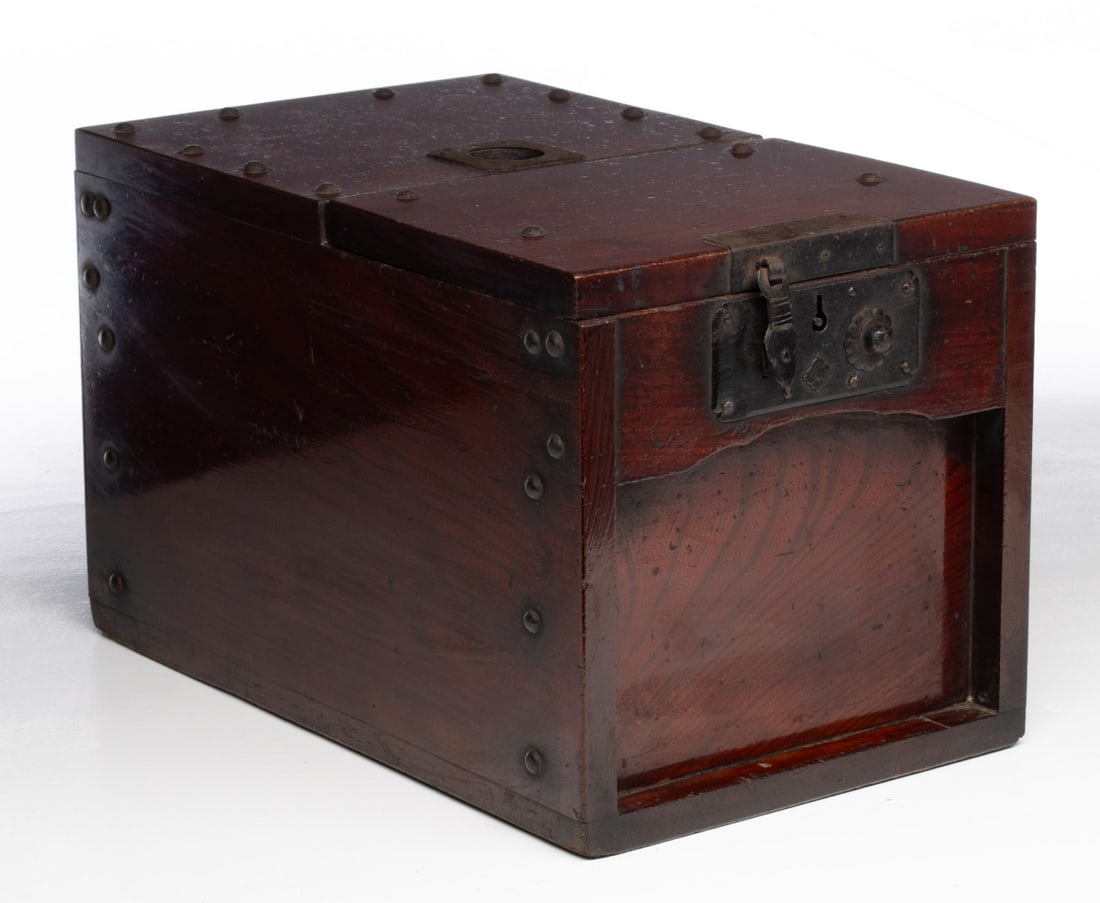 A MEIJI JAPANESE KEYAKI WOOD MONEY BOX WITH IRON MOUNTS: The finely crafted example constructed from solid keyaki wood displays a nice dark amber patina. Measures 9.5 x 15.25 x 9.5 inches. Provenance: The estate of John Adair Jr. (1942-2025), founder and