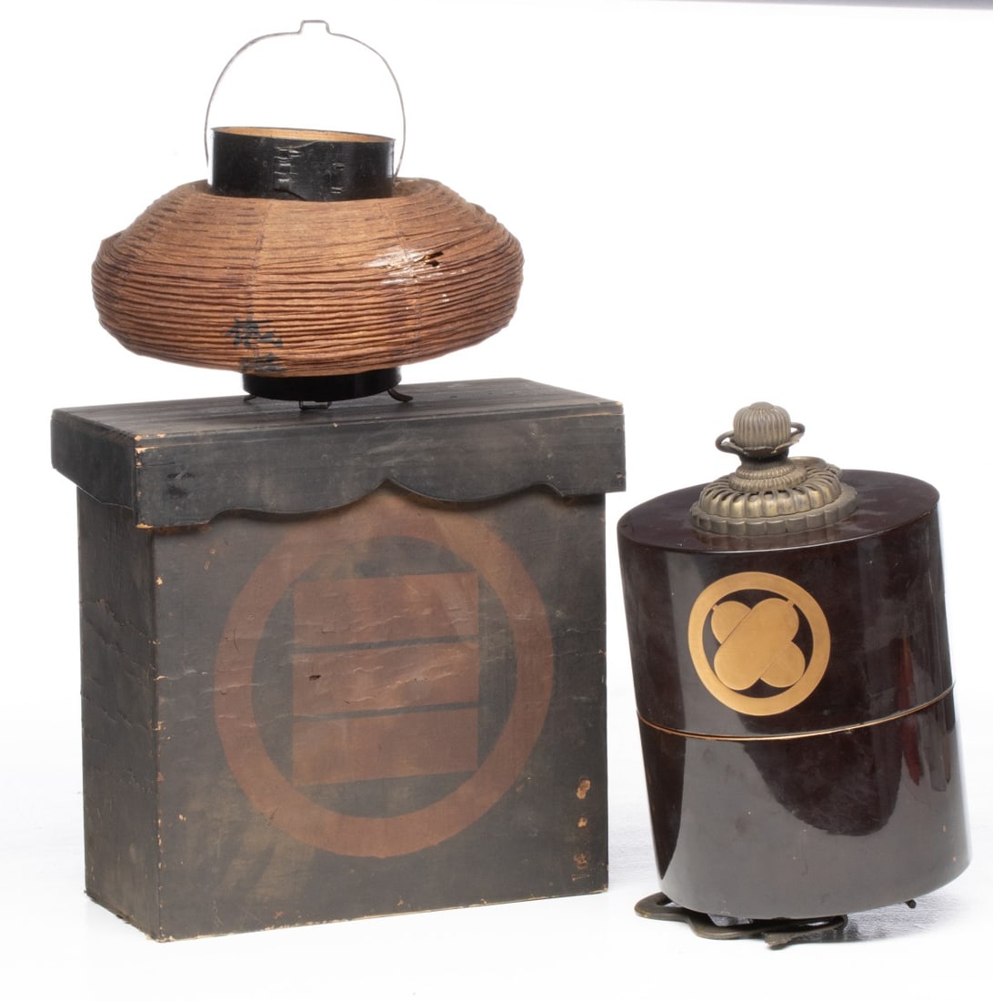 MEIJI AND OTHER JAPANESE LANTERNS AND BOX: The two lanterns include a cylindrical two-piece lacquer example with crest, plus an unassociated box. Each half of the lantern measures 4.5 x 7 inches in diameter and the box is 11.25 x 11.75 x 5.5 i